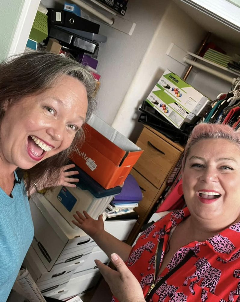 Unison and a smiling woman in front of a closet full of boxes, ready to dig in