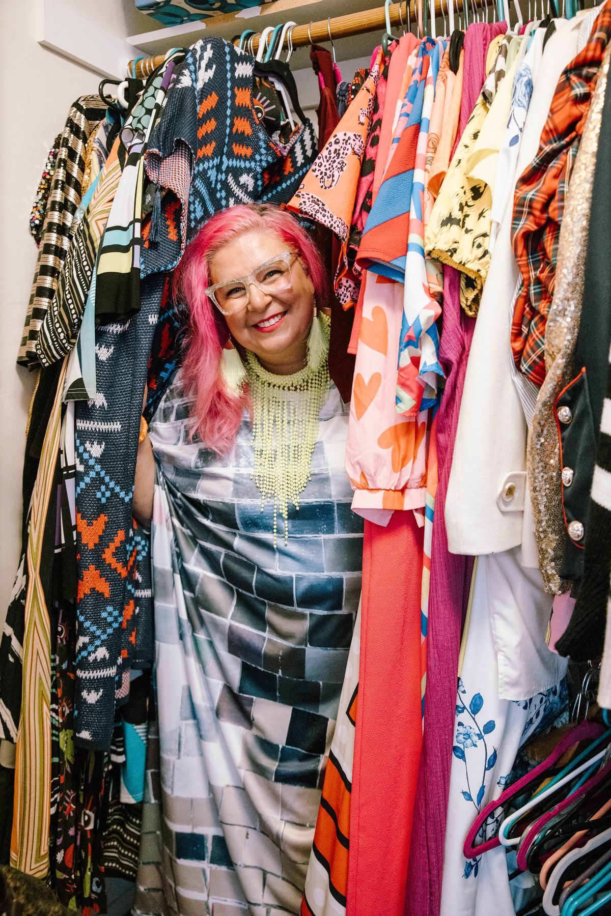 Unison Frances peeking out from a colorful closet